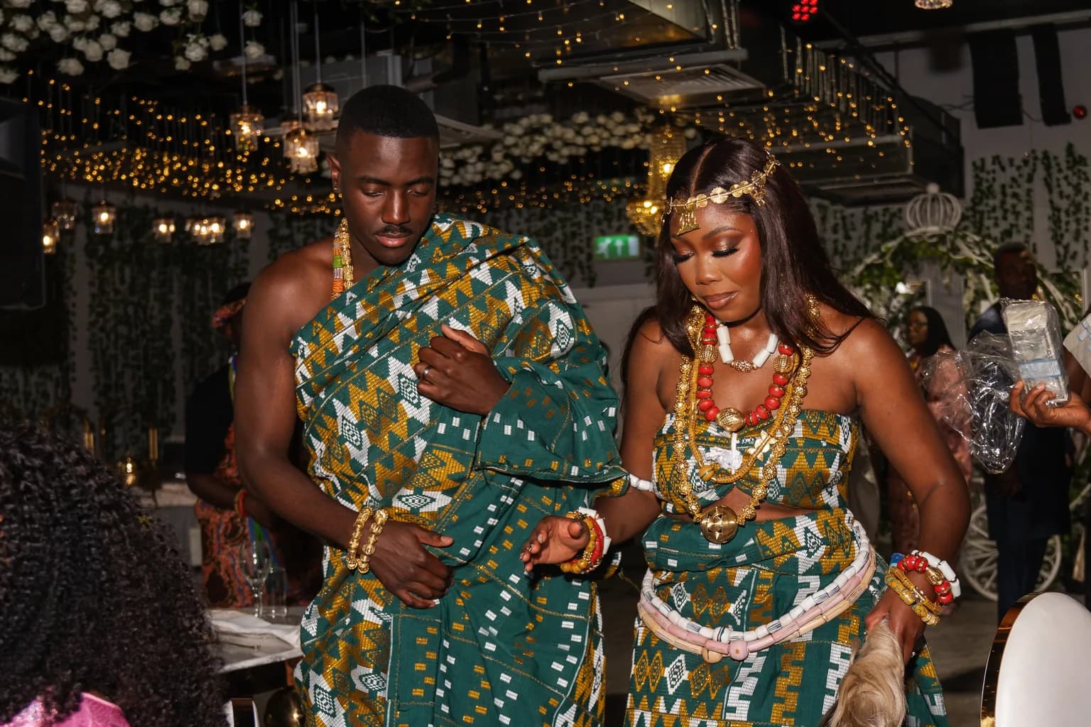 A couple in patterned traditional attire sharing a dance