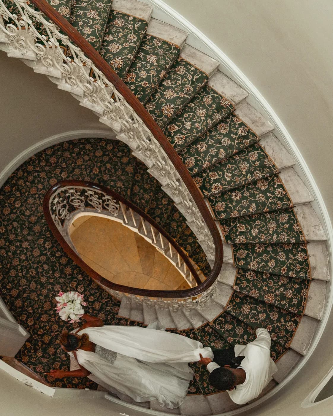 A bride descending an ornate spiral staircase