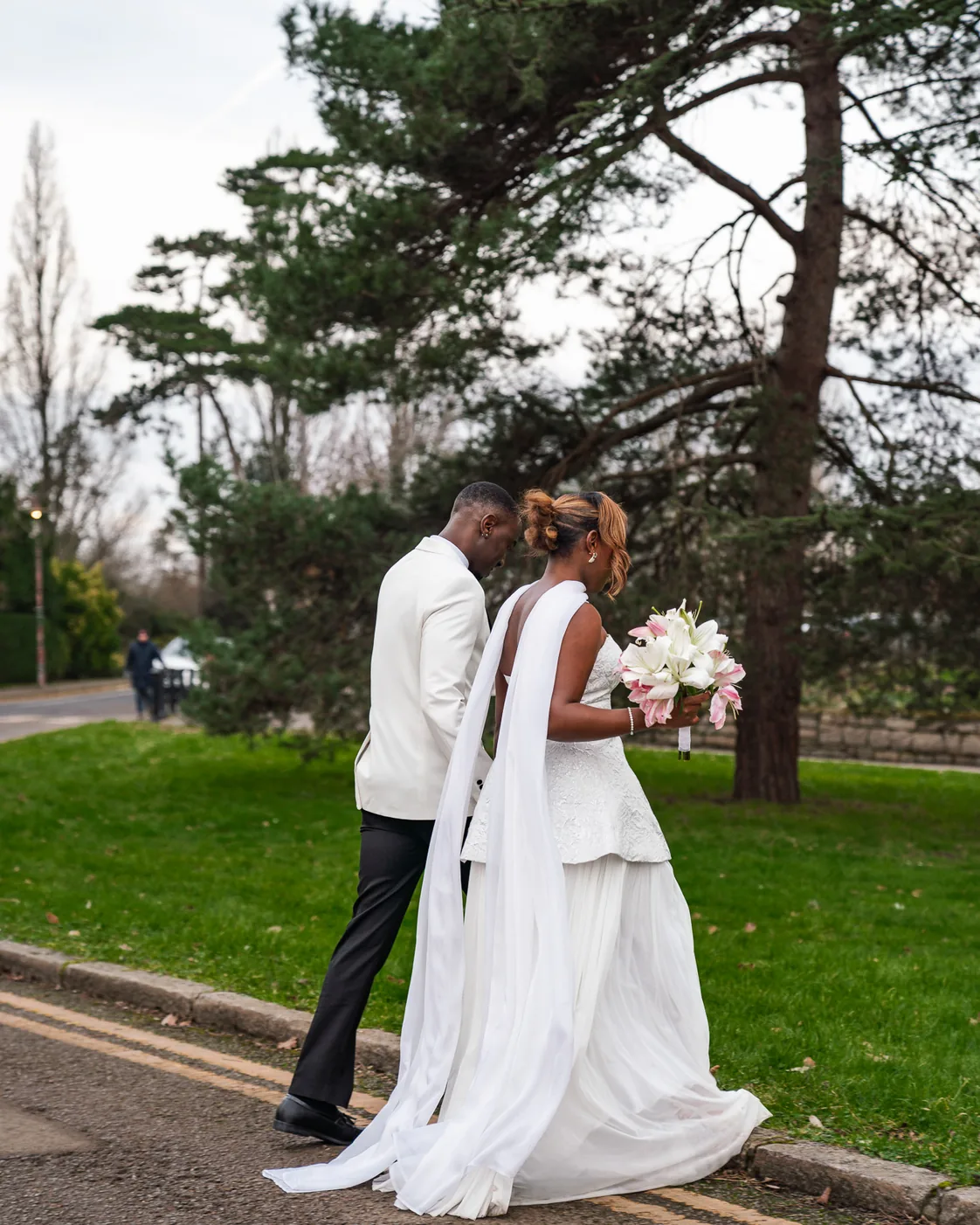 Newlyweds walking together through a garden